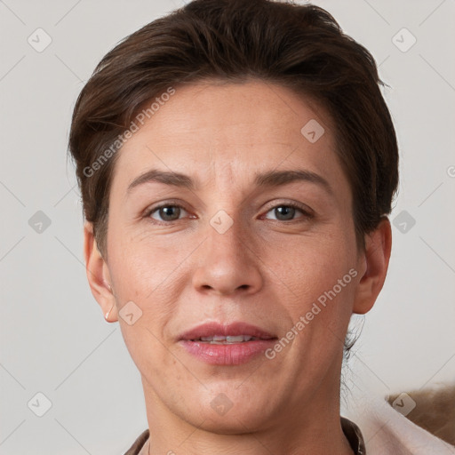 Joyful white adult female with short  brown hair and grey eyes