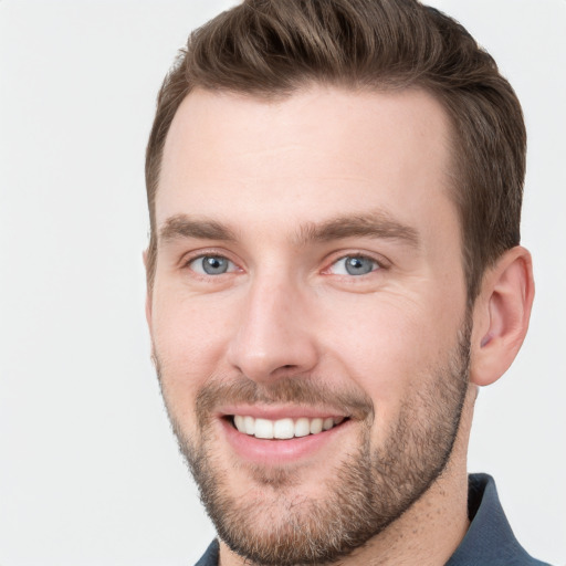 Joyful white young-adult male with short  brown hair and grey eyes