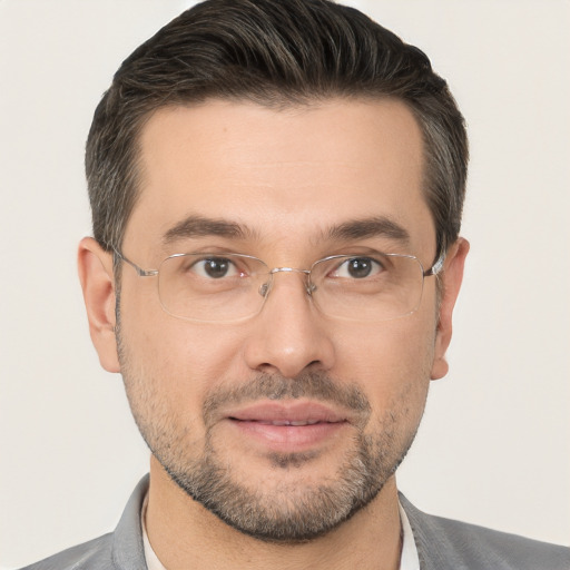 Joyful white adult male with short  brown hair and brown eyes