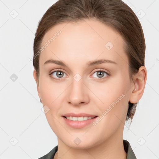 Joyful white young-adult female with medium  brown hair and grey eyes