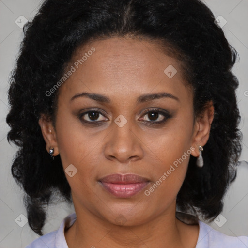 Joyful black adult female with medium  brown hair and brown eyes