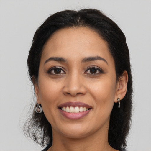 Joyful latino young-adult female with long  brown hair and brown eyes