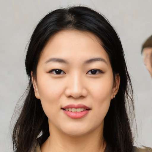 Joyful asian young-adult female with long  black hair and brown eyes