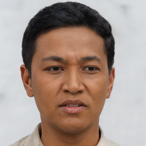 Joyful asian adult male with short  black hair and brown eyes