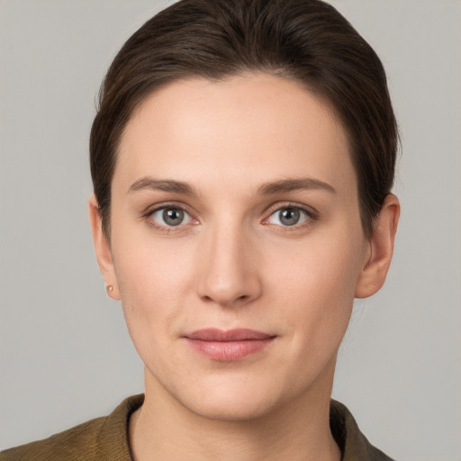 Joyful white young-adult female with short  brown hair and grey eyes