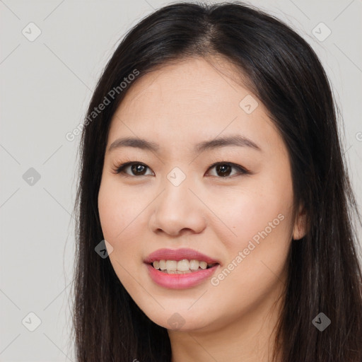 Joyful asian young-adult female with long  brown hair and brown eyes