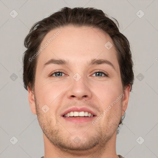 Joyful white adult male with short  brown hair and grey eyes