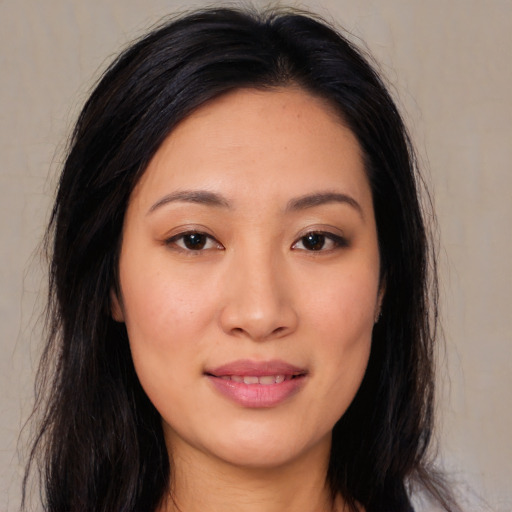Joyful asian young-adult female with long  black hair and brown eyes