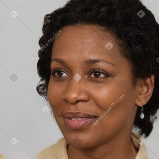 Joyful black adult female with short  brown hair and brown eyes