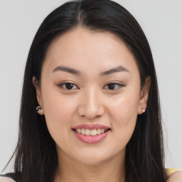 Joyful asian young-adult female with long  brown hair and brown eyes