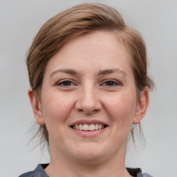 Joyful white young-adult female with medium  brown hair and grey eyes