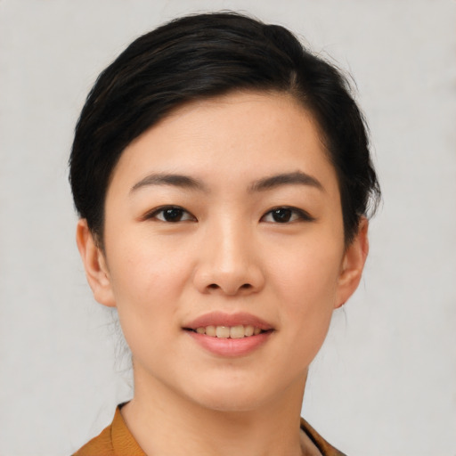 Joyful asian young-adult female with short  black hair and brown eyes