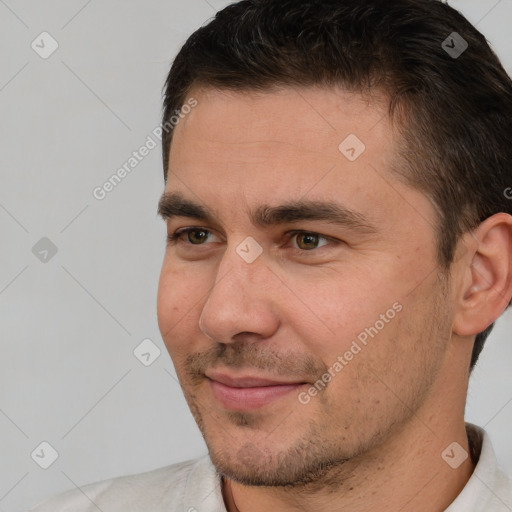 Joyful white young-adult male with short  brown hair and brown eyes