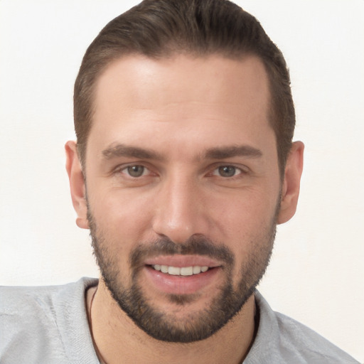 Joyful white young-adult male with short  brown hair and brown eyes