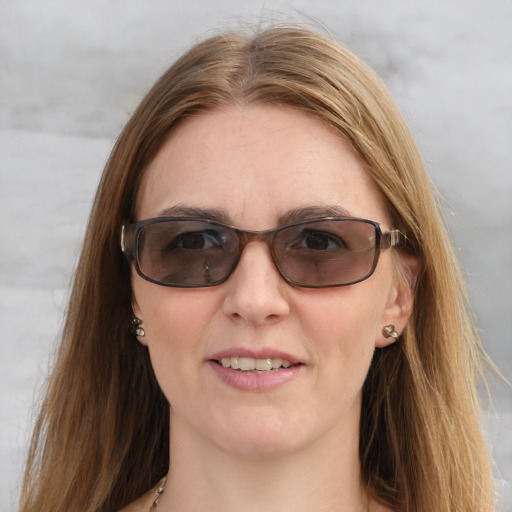 Joyful white young-adult female with long  brown hair and blue eyes