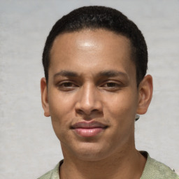 Joyful latino young-adult male with short  brown hair and brown eyes