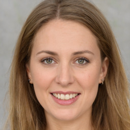 Joyful white young-adult female with long  brown hair and grey eyes