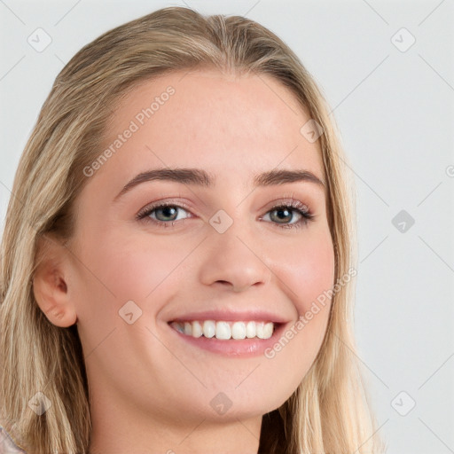 Joyful white young-adult female with long  brown hair and blue eyes