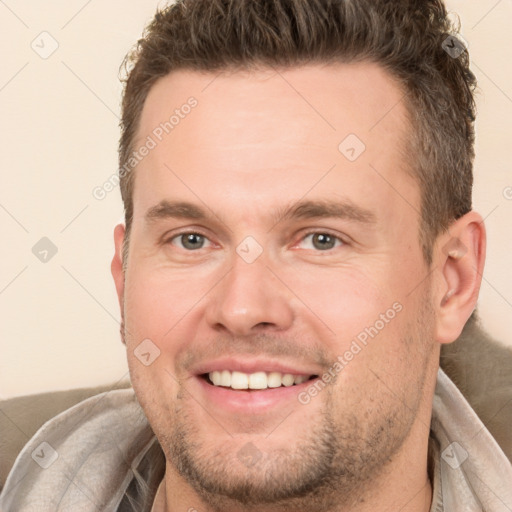 Joyful white adult male with short  brown hair and brown eyes