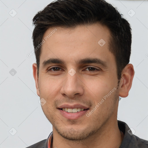 Joyful white young-adult male with short  brown hair and brown eyes