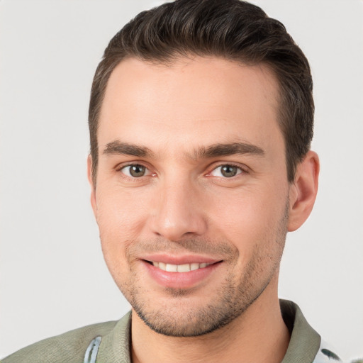 Joyful white young-adult male with short  brown hair and brown eyes