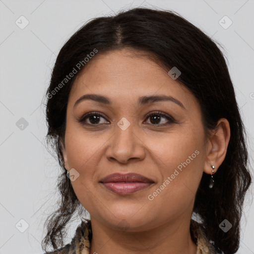 Joyful latino adult female with medium  brown hair and brown eyes