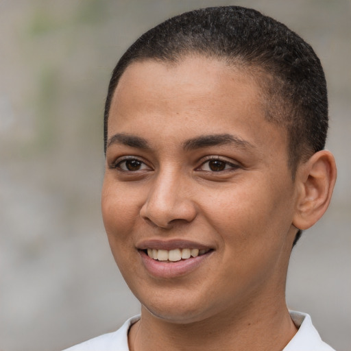 Joyful black young-adult female with short  brown hair and brown eyes