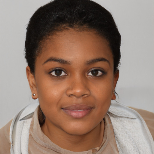 Joyful black child female with short  brown hair and brown eyes
