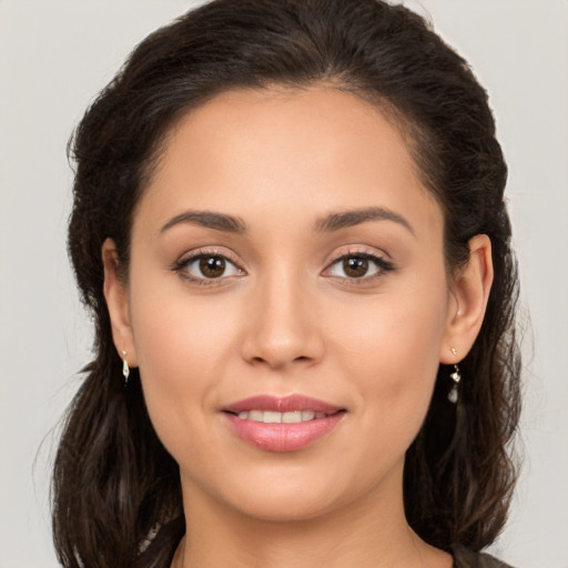 Joyful white young-adult female with long  brown hair and brown eyes