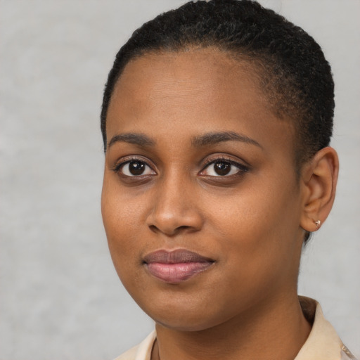 Joyful black young-adult female with short  brown hair and brown eyes