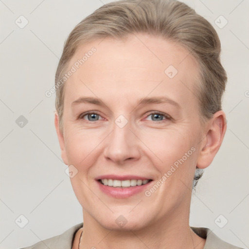 Joyful white adult female with short  brown hair and grey eyes