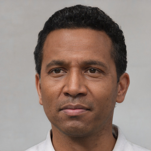 Neutral latino adult male with short  black hair and brown eyes