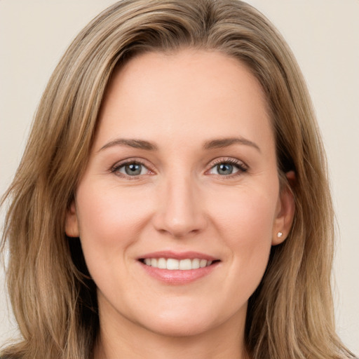 Joyful white young-adult female with long  brown hair and green eyes