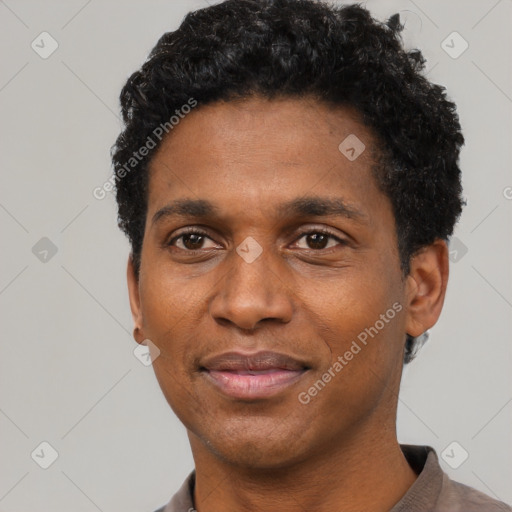 Joyful black young-adult male with short  black hair and brown eyes