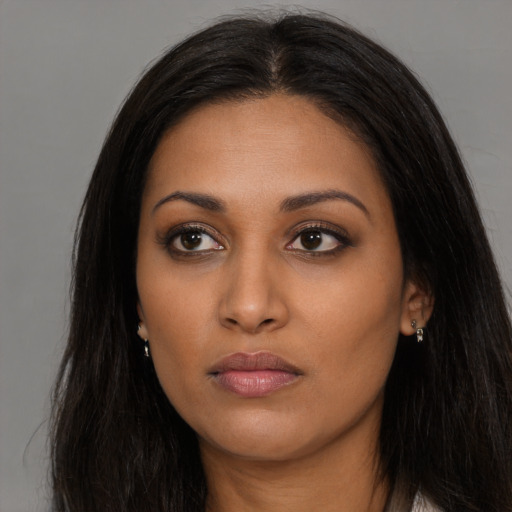 Neutral latino young-adult female with long  brown hair and brown eyes