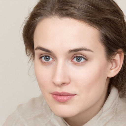 Joyful white young-adult female with medium  brown hair and green eyes