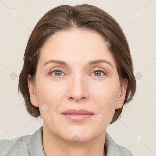 Joyful white adult female with medium  brown hair and grey eyes