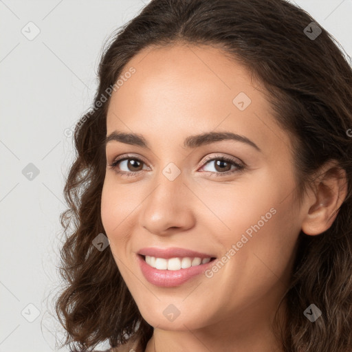 Joyful white young-adult female with long  brown hair and brown eyes