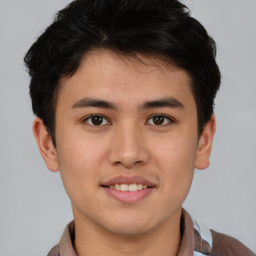 Joyful asian young-adult male with short  brown hair and brown eyes