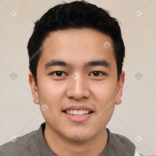 Joyful asian young-adult male with short  black hair and brown eyes