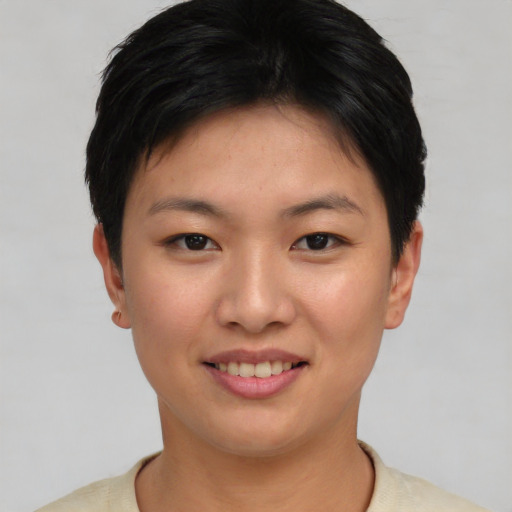 Joyful asian young-adult female with short  brown hair and brown eyes