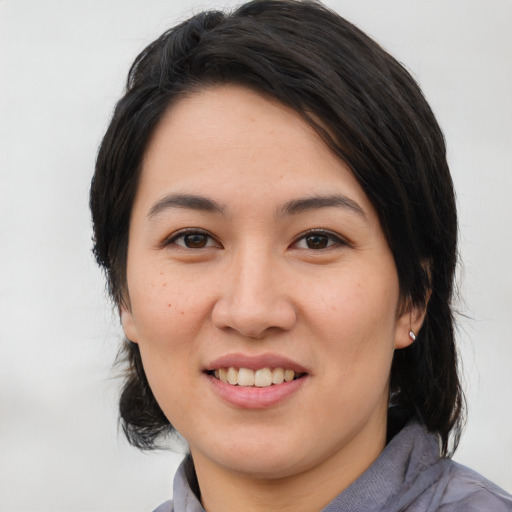 Joyful white young-adult female with medium  black hair and brown eyes