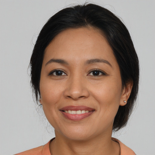Joyful latino young-adult female with medium  black hair and brown eyes