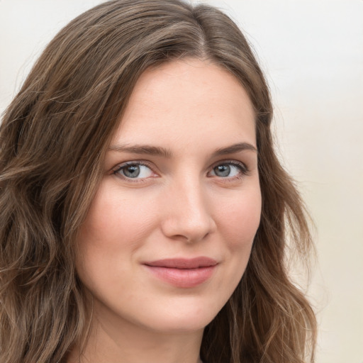 Joyful white young-adult female with long  brown hair and green eyes