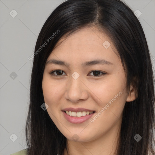 Joyful asian young-adult female with long  brown hair and brown eyes