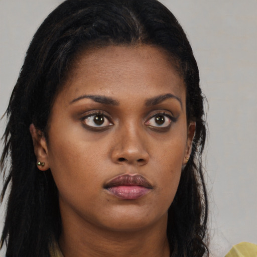 Neutral black young-adult female with long  brown hair and brown eyes