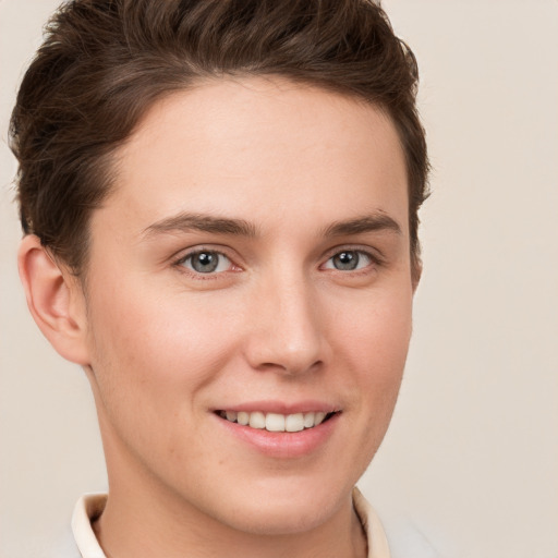 Joyful white young-adult female with short  brown hair and grey eyes