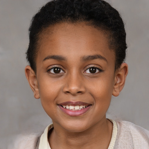 Joyful black child female with short  brown hair and brown eyes