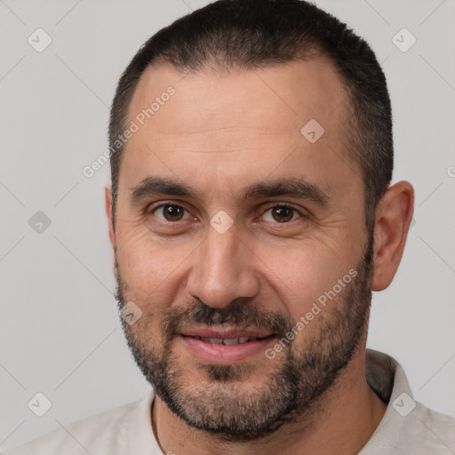 Joyful white adult male with short  brown hair and brown eyes