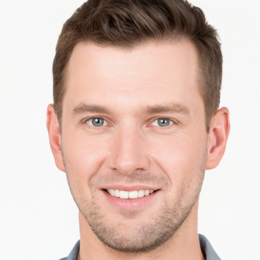 Joyful white young-adult male with short  brown hair and grey eyes